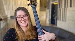Bass player Crystal Rebone holding string bass