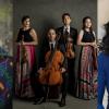 Image of a four string players posing, looking at the camera and each holding their instrument.