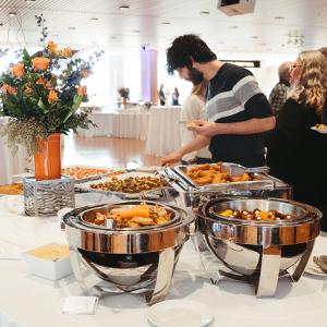 Bearded man filling a plate at buffet table