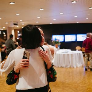 Two women hugging in Krannert Center Lobby